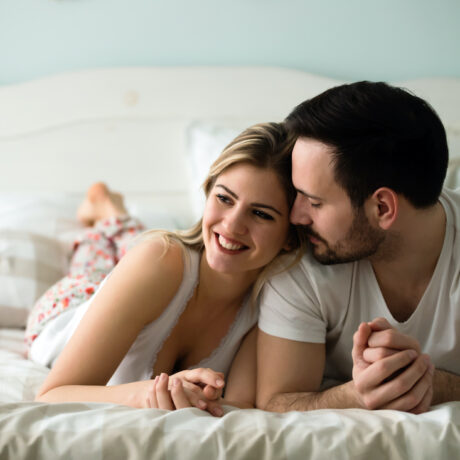 Couple in love wearing pajamas lying in bed